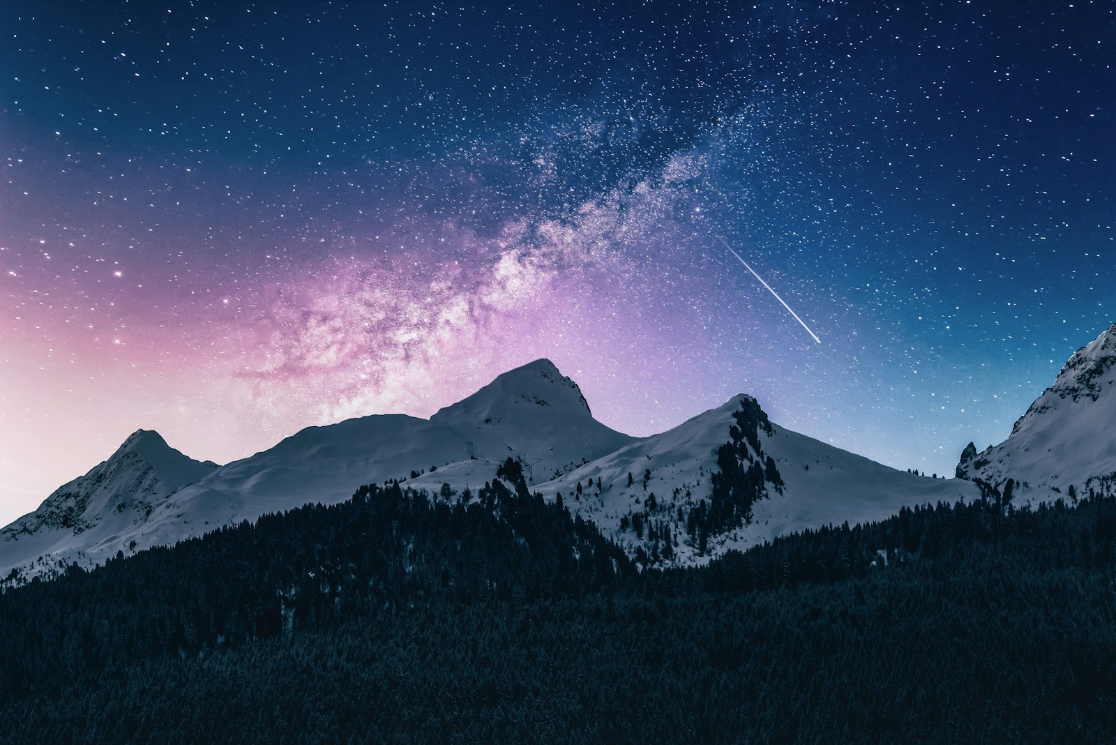 Snowy mountains under a starry sky